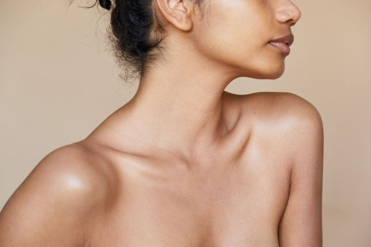 Woman looking over her shoulder with smooth skin